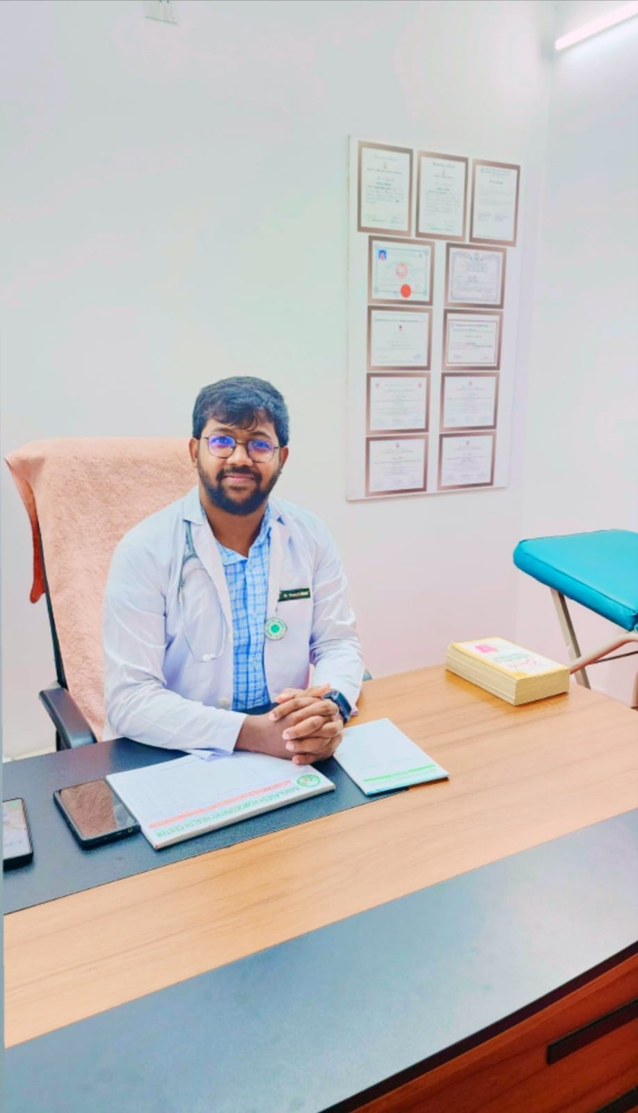Dr. Ahmed seated at the chamber desk